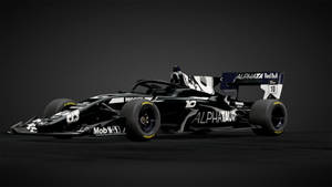 黑暗攝影棚地板上的黑白AlphaTauri F1賽車，編號10。
