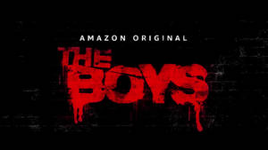黑色磚牆上帶有滴落油漆的紅色塗鴉文字「The Boys」。