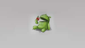 綠色Android吉祥物在灰色背景上拿著紅蘋果