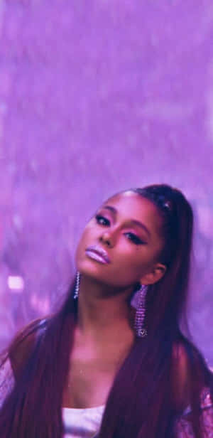 Ariana Grande 在紫色燈光下的肖像，閃亮嘴唇和垂墜耳環。 — 愛莉安娜·格蘭德 壁紙