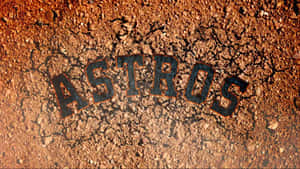 裂開的泥土上刻有「ASTROS」一詞，以粗體黑色字母和橙色輪廓呈現。 — 侯斯頓太空人 壁紙