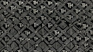 黑白幾何牆紙，帶有重複的風格化TM標誌。