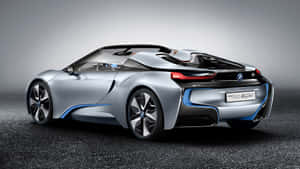 銀色BMW i8 Spyder概念車，帶有藍色飾條和紅色尾燈，在工作室環境中。