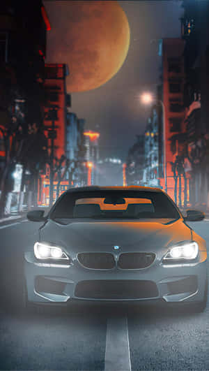 銀色BMW跑車在霓虹燈照亮下的城市街道，背景是巨大的橙色月亮。 — 月色夜空 壁紙