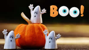 三個鬼魂公仔和一個有「BOO！」文字和眼睛的南瓜。