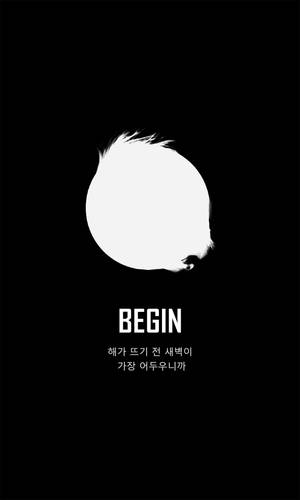 黑色背景上有一個發光的白色圓形，邊緣模糊，並帶有「BEGIN」字樣。