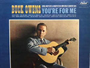Buck Owens 在復古專輯封面上手持原聲結他。
