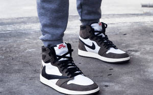 穿著灰色運動褲和黑白灰色Nike Air Jordan波鞋的人在路上。