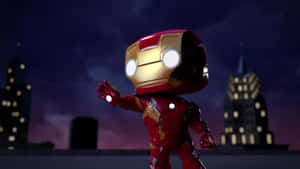 Chibi Iron Man 喺屋頂，發光嘅眼睛同斥力手對住城市天際線嘅夜晚場景。 — 鐵甲奇俠標誌 壁紙