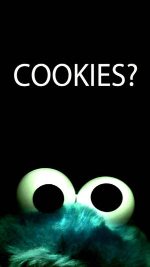 Cookie Monster 發光的眼睛和藍綠色毛髮，背景為黑色，並有文字 COOKIES?。 — 可愛卡通 壁紙