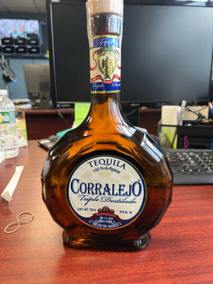 辦公室木桌上的一瓶 Corralejo 龍舌蘭酒。