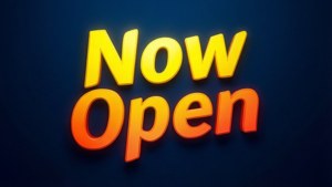 深藍色背景上黃色和橙色的發光「Now Open」標誌