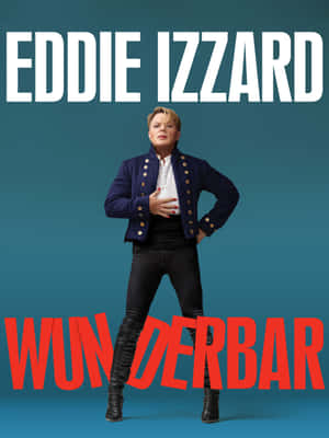 Eddie Izzard 身穿海軍藍外套和黑色長褲，搭配紅色和白色文字擺姿勢。 — 奇雲·哈特 壁紙