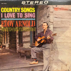Eddy Arnold 在復古鄉村音樂專輯封面中，在質樸的小屋門廊上彈奏結他。