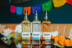 三支 El Jimador 龍舌蘭酒瓶，配有萬壽菊和 papel picado 裝飾。