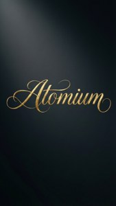 深色漸變背景上的金色草書單詞 Atomium
