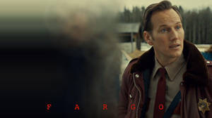 一名身穿冬季外套的警察站在雪地鄉村場景中，帶有'FARGO'文字。