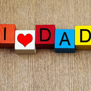 彩色木塊在木面上拼出 I heart DAD