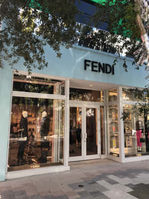 FENDI時裝店正面，有人體模型和上方樹枝。 — iPad 第9代 壁紙