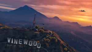 日落時山丘上的Vinewood標誌，飛機飛過上空。