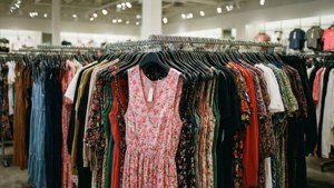 服裝店衣架上掛著一排色彩繽紛的連衣裙。