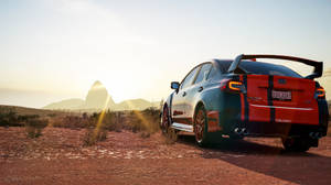 紅色和藍色的Subaru WRX STI停在日落時分的沙漠公路上。 — 極限競速：地平線4 壁紙
