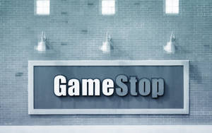 灰色磚牆上的GameStop商店標誌，配有三盞天花燈。 — Cia標誌 壁紙