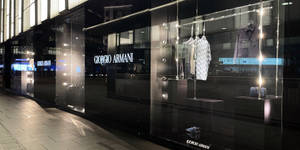 夜間Giorgio Armani櫥窗展示，聚光燈下的服裝和鞋子。