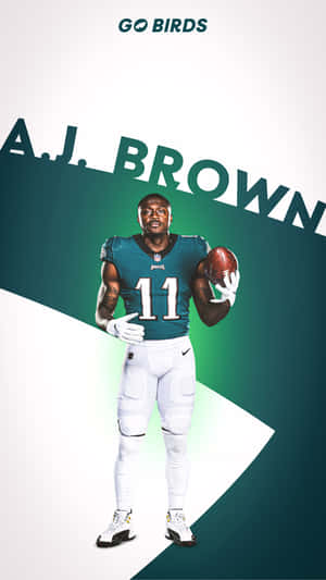 橄欖球運動員 A.J. Brown 身穿老鷹隊裝備，手持帶有球隊標誌的球。