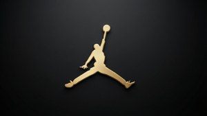 金色Jordan標誌，籃球運動員在黑色背景上入樽