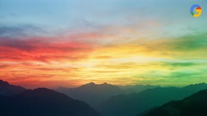 山脈上色彩繽紛的日落，層疊的山峰和漸變的天空。 — Google 壁紙