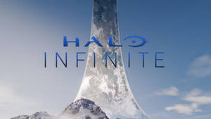 Halo Infinite 標誌在從雪山中出現的發光環上方。