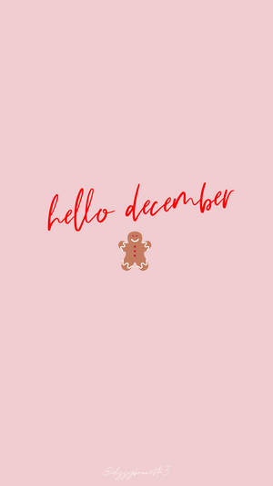 粉紅色背景，上面有紅色 hello december 文字和一個薑餅人。 — 聖誕節 iPhone 壁紙