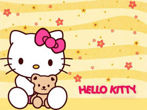 Hello Kitty 喺黃色星星背景上抱住一隻泰迪熊。
