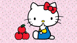 Hello Kitty 手持黃色物體，在粉紅色圖案背景上的三個紅蘋果旁邊。