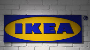 白色磚牆上的藍色和黃色 IKEA 標誌牌。