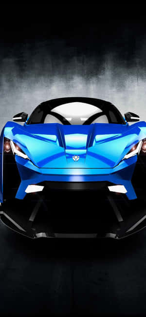 藍色跑車在黑暗煙霧環境中帶有發光的前燈。 — Realme Narzo 100x 壁紙