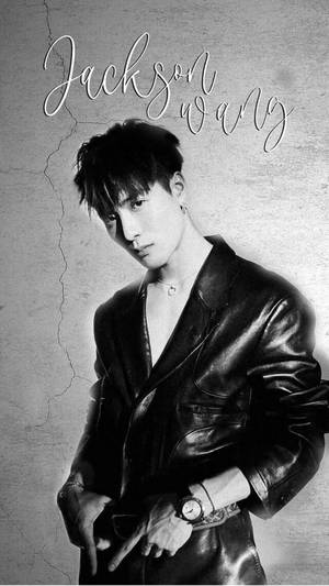 Jackson Wang 身穿皮褸，以裂牆為背景擺姿勢，上方有他的名字。 — 成振宇 壁紙