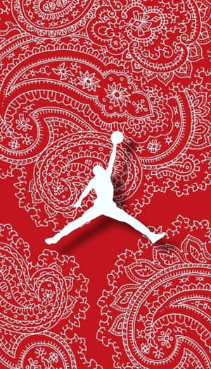 白色籃球運動員剪影在紅色佩斯利背景上入樽。
