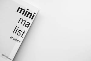 Julia Schonlau 所著的極簡書籍《minimalist graphics》放在白色背景上。 — 簡約 壁紙
