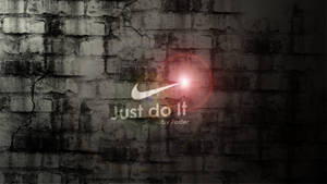 Nike 標誌帶有 'Just do it' 口號在裂縫磚牆上發光。 — Cia標誌 壁紙