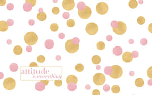 粉紅色和金色的五彩紙屑，上面有「attitude is everything」這句話，背景為白色。