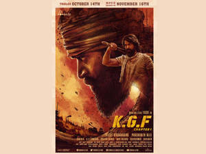 K.G.F Chapter 1 的電影海報，展示一個手持武器的男人和火焰中的巨大面孔。
