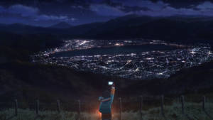 山頂上的人正在星空下拍攝夜晚閃爍的城市照片 — 夜晚 GIF 壁紙