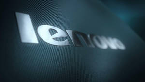 光滑的銀色 Lenovo 標誌，位於帶有紋理的深藍綠色表面上。 — 凌志標誌 GIF 壁紙
