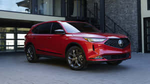 紅色Acura SUV停泊在現代石頭和玻璃建築前。 — 5120x2880 壁紙