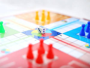 色彩繽紛的棋盤遊戲，聚焦於棋子和骰子。