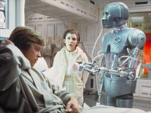 Luke Skywalker 在醫療艙的病床上，與 Leia 公主和一個機械人。 — 機械人 壁紙