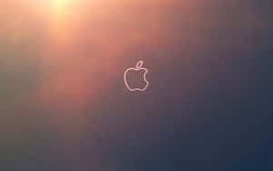 Apple標誌剪影在日落漸變背景上發光。 — Mac GIF 壁紙