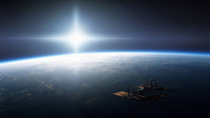 太空站繞地球運行，太陽在行星的曲線上方明亮地照耀。